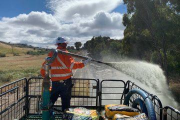 man spraying hydromulch out of a cannon